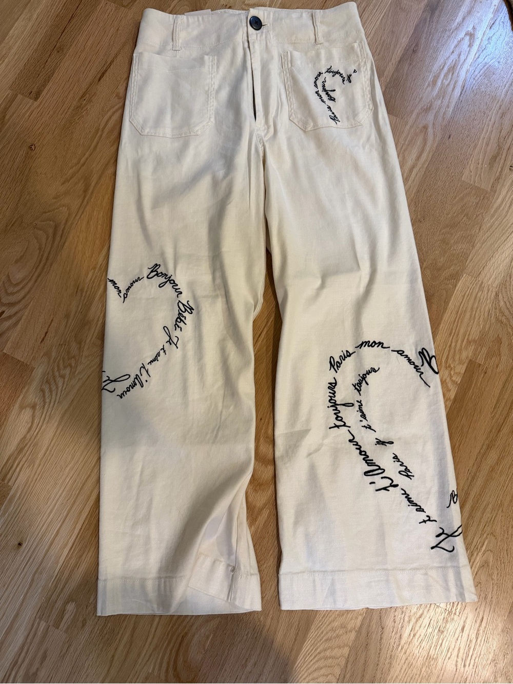 Cream Wide-Leg Pants with Black Script Heart Details from Anthropologie